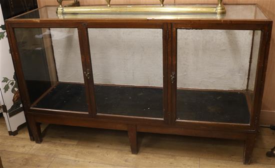 A 1920s hardwood shop display cabinet W.179cm, D.59cm, H.108cm